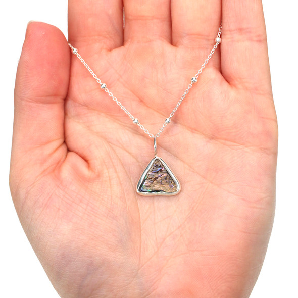 Abalone Triangle Charm on model for color reference.