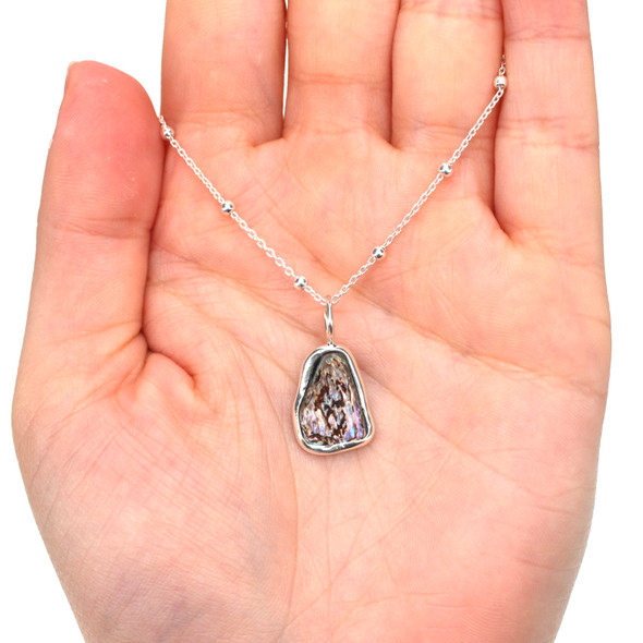 Abalone Shimmer Swirl Charm on model for color reference.