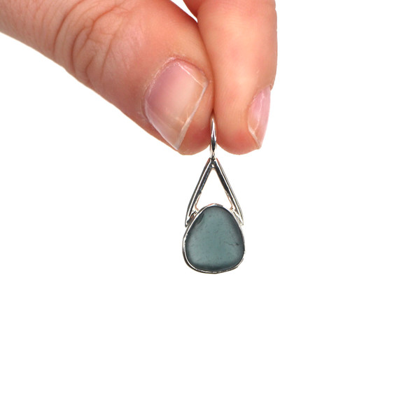 Olive Sea Glass Lunar Drop Charm held to the light