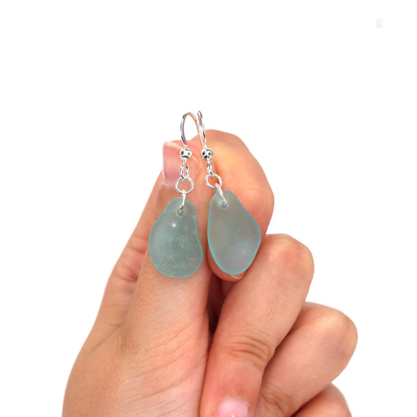 Aqua Elongated Sea Glass Simply Drilled Earrings on model for color reference. Aqua Elongated Sea Glass Simply Drilled Earrings on model for color reference.