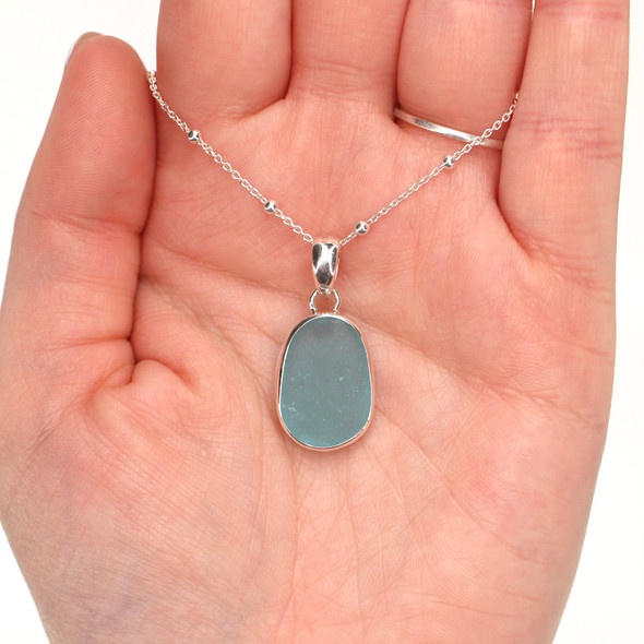 Aqua Oval Sea Glass Bezel Set Necklace on model for color reference. 
