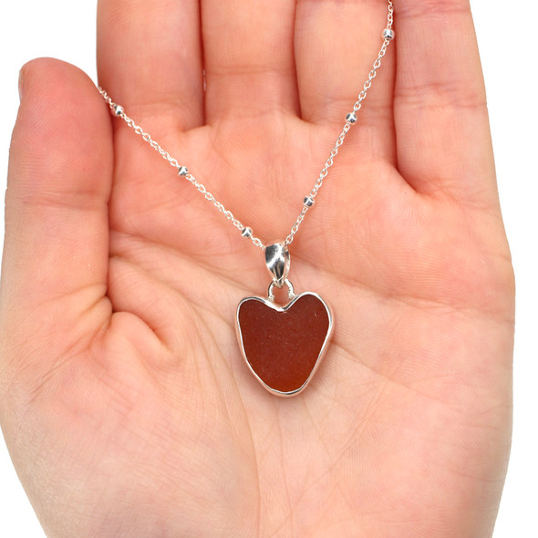 Amber Sea Glass Heart Necklace on model for color reference.