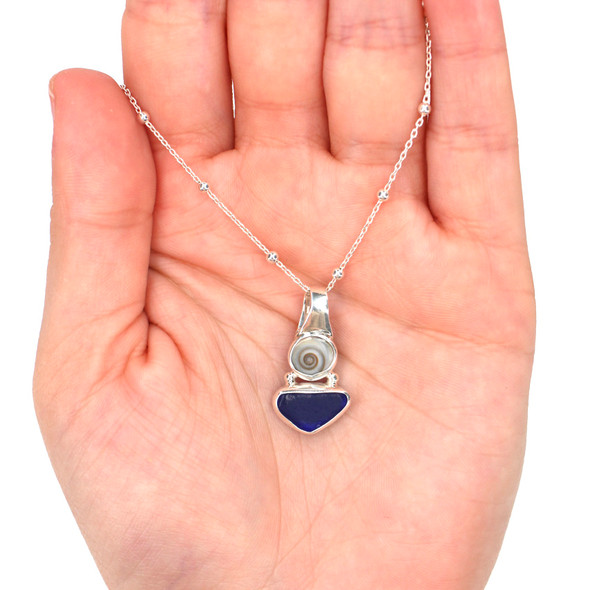 Cobalt Sea Glass and Swirl Shell Petite Slide Necklace on model for color reference. Cobalt Sea Glass and Swirl Shell Petite Slide Necklace on model for color reference.