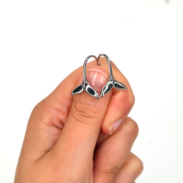 Sterling Silver Whale Tail Earring on model for color reference. Sterling Silver Whale Tail Earring on model for color reference.