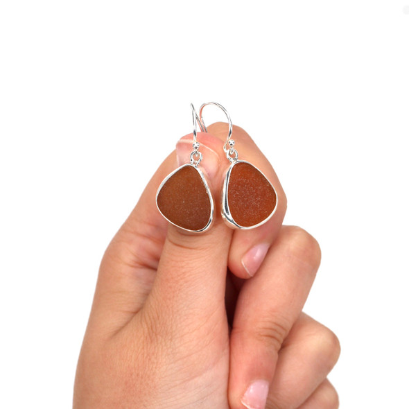 Amber Sea Glass Single Bezel Earring on model for color reference. Amber Sea Glass Single Bezel Earring on model for color reference.