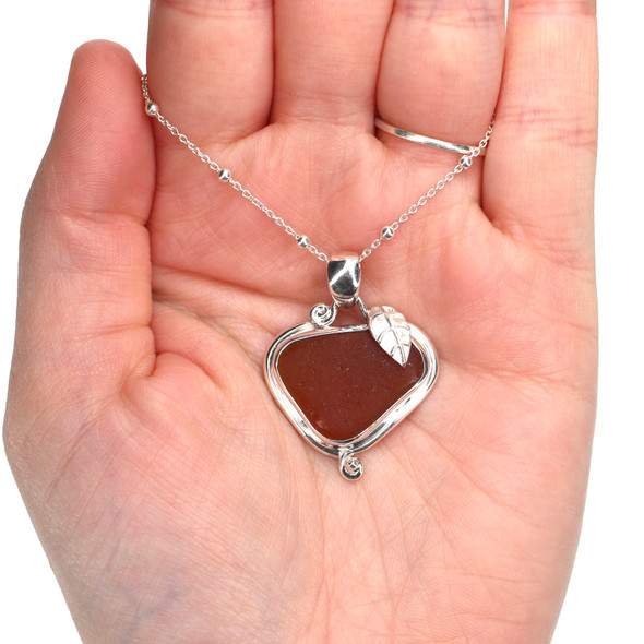 Amber Sea Glass Little Leaf Necklace on model for color reference. Amber Sea Glass Little Leaf Necklace on model for color reference.