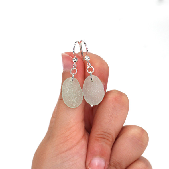 Seafoam Elongated Sea Glass Simply Drilled Earrings on model for color reference. Seafoam Elongated Sea Glass Simply Drilled Earrings on model for color reference.