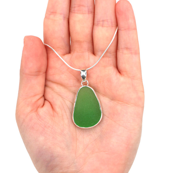 Green Teardrop Sea Glass Single Bezel Necklace on model for color reference. Green Teardrop Sea Glass Single Bezel Necklace on model for color reference.