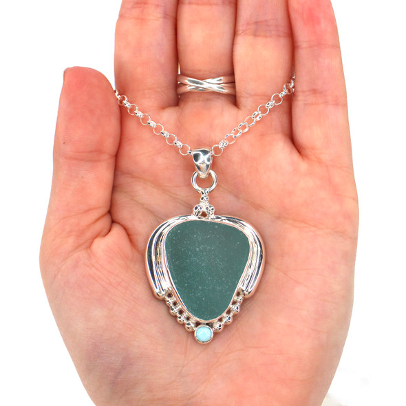 Aqua Allure Triangle Sea Glass and Larimar Ocean Empress Necklace on model for color reference. Aqua Allure Triangle Sea Glass and Larimar Ocean Empress Necklace on model for color reference.