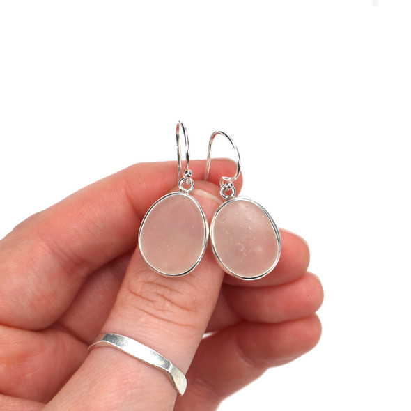 White Sea Glass Single Bezel Earring on model for color reference. White Sea Glass Single Bezel Earring on model for color reference.