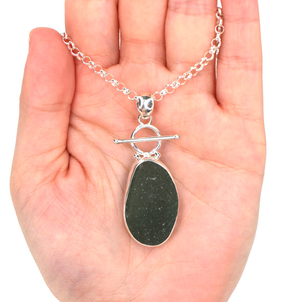 Olive Sea Glass Toggle Necklace on model for color reference. Olive Sea Glass Toggle Necklace on model for color reference.