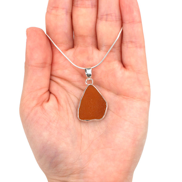 Amber Sea Glass Single Bezel Necklace on model for color reference. Amber Sea Glass Single Bezel Necklace on model for color reference.