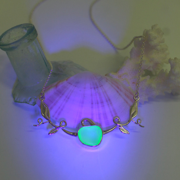 Seafoam UV Sea Glass Pumpkin Necklace on 16-18 necklace under a black light Seafoam UV Sea Glass Pumpkin Necklace on 16-18 necklace under a black light