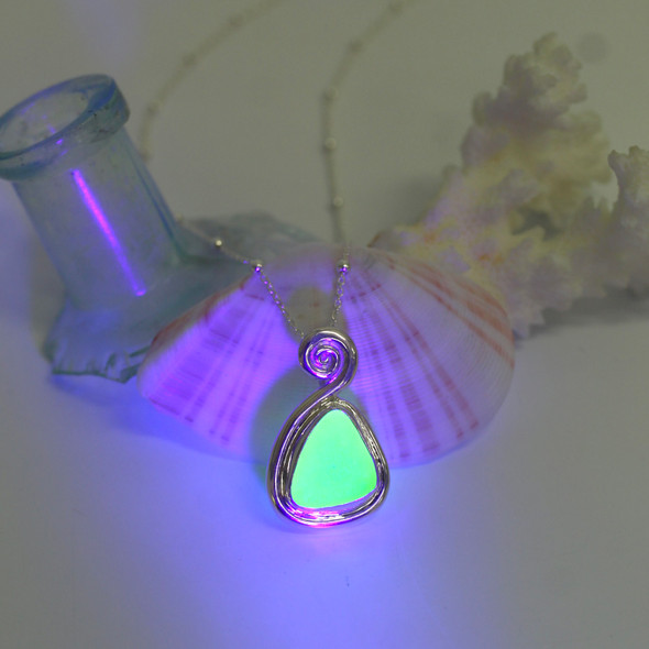 Seafoam UV Sea Glass Swirl Necklace under a black light Seafoam UV Sea Glass Swirl Necklace under a black light