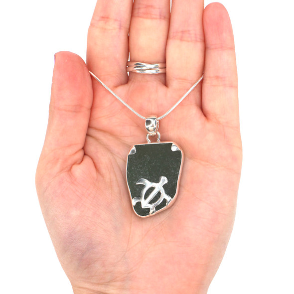 Olive Sea Glass Swimming Turtle Necklace on model for color reference.
Olive Sea Glass Swimming Turtle Necklace on model for color reference.