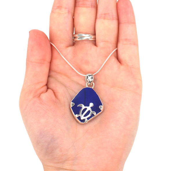 Cobalt Sea Glass Swimming Turtle Necklace on model for color reference.
Cobalt Sea Glass Swimming Turtle Necklace on model for color reference.