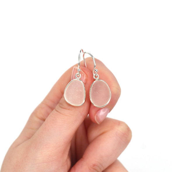 White Crisp Sea Glass Bezel Earrings on model for color reference.