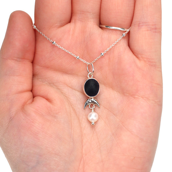 Cobalt Midnight Sea Glass Arch and Pearl Necklace on model for color reference. Cobalt Midnight Sea Glass Arch and Pearl Necklace on model for color reference.