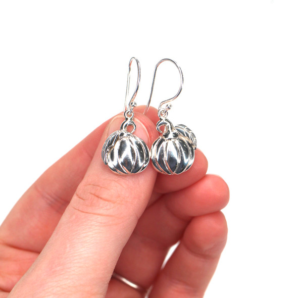 Sterling Silver Pumpkin Earrings on model for color reference. Sterling Silver Pumpkin Earrings on model for color reference.
