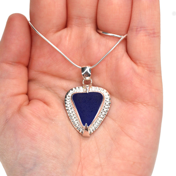 Cobalt Triangle Sea Glass Rising Sun Necklace on model for color reference. Cobalt Triangle Sea Glass Rising Sun Necklace on model for color reference.