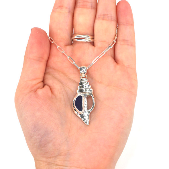 Cobalt Midnight Sea Glass Conch Shell Necklace on model for color reference.
Cobalt Midnight Sea Glass Conch Shell Necklace on model for color reference.