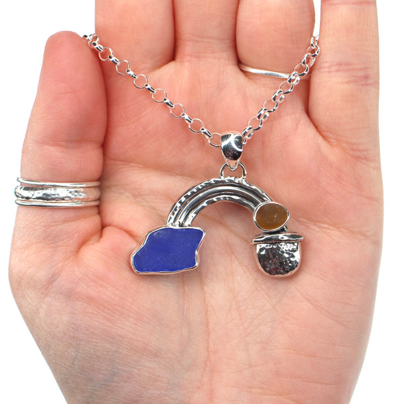 Cobalt Sea Glass Pot of Gold Rainbow Necklace in hand for color reference