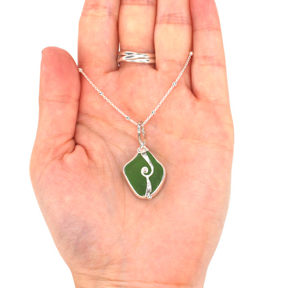Green Sea Glass Wave Necklace on model for color reference.
Green Sea Glass Wave Necklace on model for color reference.