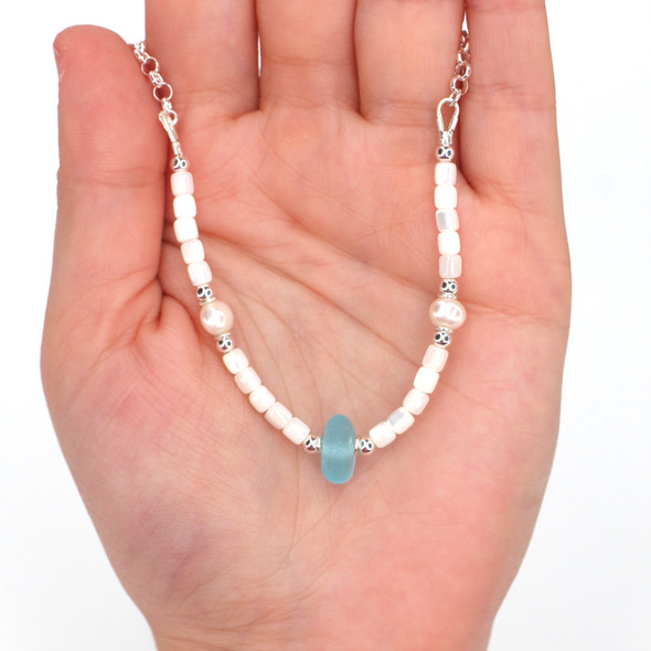 Turquoise Bright Sea Glass Sea Glass Pearl and Mother of Pearl Pearl Necklace on model for color reference. Turquoise Bright Sea Glass Sea Glass Pearl and Mother of Pearl Pearl Necklace on model for color reference.