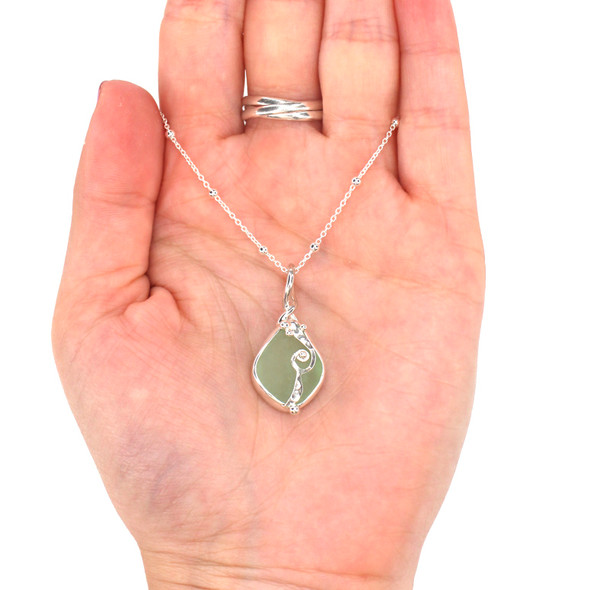 Seafoam Bright Sea Glass Wave Necklace on model for color reference.
Seafoam Bright Sea Glass Wave Necklace on model for color reference.