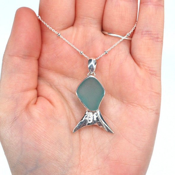 Aqua Sea Glass Fish Necklace on palm for size reference