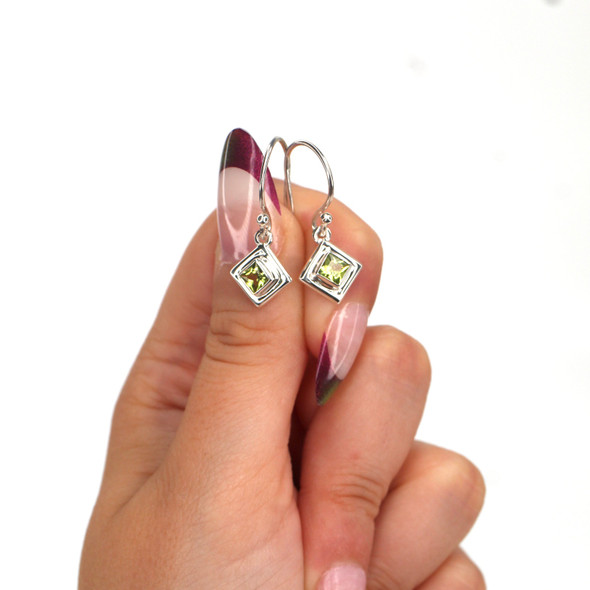 Peridot Gemstone Double Bezel Earrings on model for color reference. Peridot Gemstone Double Bezel Earrings on model for color reference.