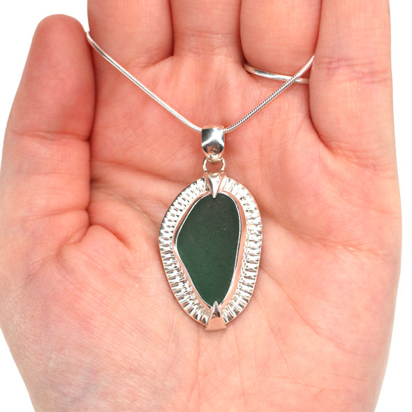 Olive Sea Glass Rising Sun Necklace on model for color reference. Olive Sea Glass Rising Sun Necklace on model for color reference.