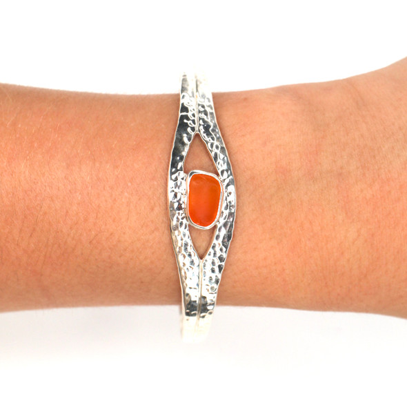 Tangerine Sea Glass Hammered Cuff Bracelet on model for color reference. Tangerine Sea Glass Hammered Cuff Bracelet on model for color reference.