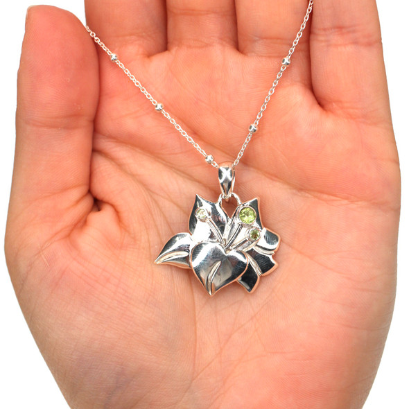 Sterling Silver and Peridot Stargazer Flower Necklace on model for color reference.