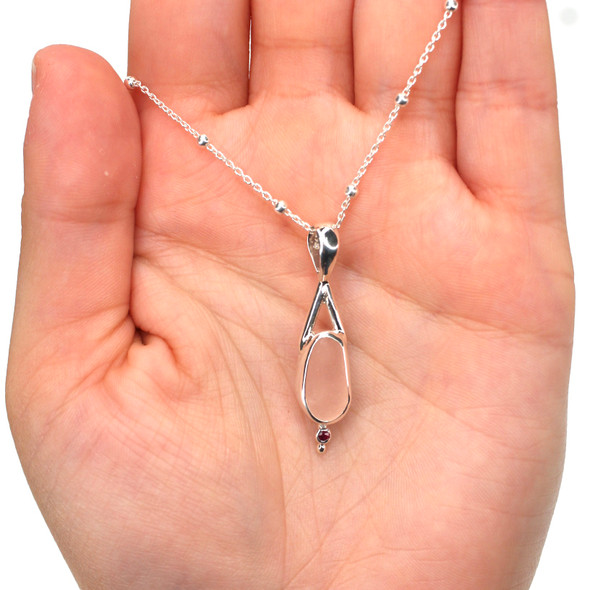 Pink Sea Glass and Ruby Lunar Drop Necklace on model for color reference.