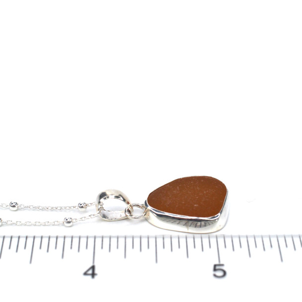 Honey Amber Sea Glass Single Bezel Necklace on ruler for size reference.