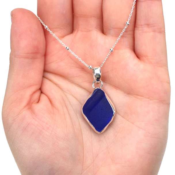 Cobalt Bottle Lip Sea Glass Single Bezel Necklace on model for color reference.