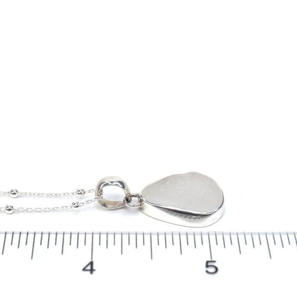 White Sea Glass Single Bezel Necklace on ruler for size reference.