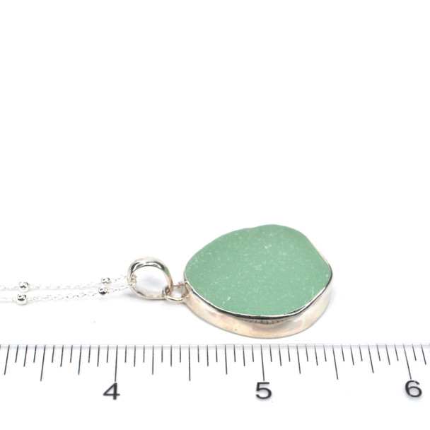 Seafoam Round Sea Glass Single Bezel Necklace on ruler for size reference.