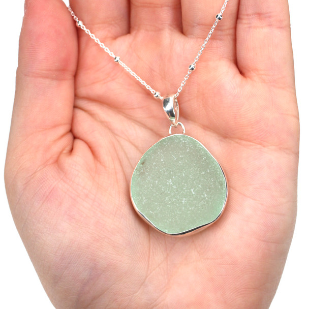 Seafoam Round Sea Glass Single Bezel Necklace on model for color reference.