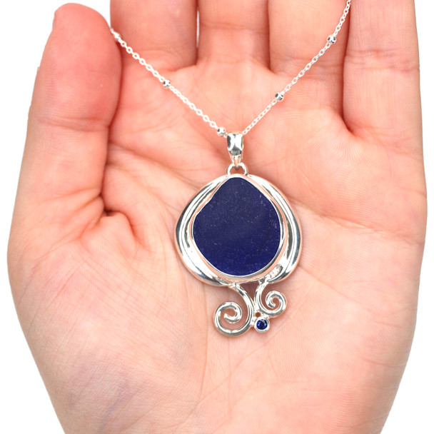 Cobalt Sea Glass and Sapphire Ocean Curl Necklace on model for color reference.
