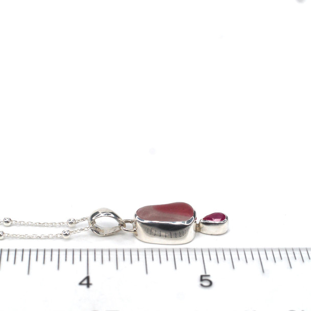 Pink Aura Sea Glass and Ruby Double Necklace on ruler for size reference.