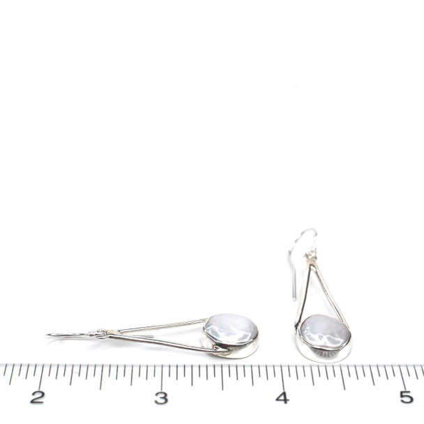 Pearl Lunar Drop Earring on ruler for size reference.