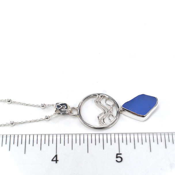 Cornflower Sea Glass Ocean Wave Necklace on ruler for size reference.