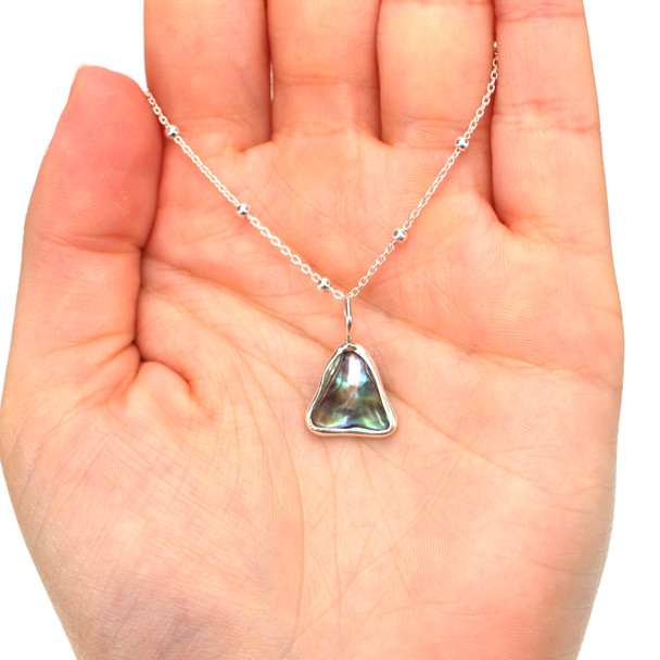 Abalone Mermaid Tail Charm on model for color reference.