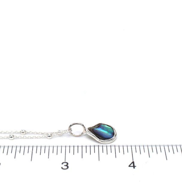 Abalone Gumdrop Charm on ruler for size reference.