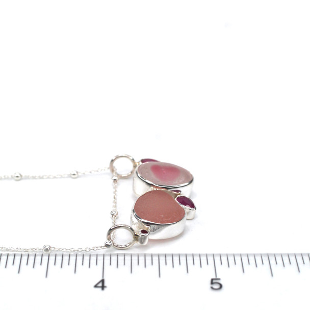 Pink Sea Glass and Ruby Slide Necklace on ruler for size reference.