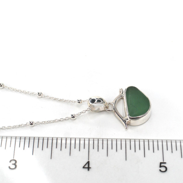 Olive Sea Glass Wave Necklace on ruler for size reference. 