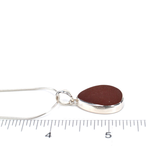 Amber Smooth Drop Sea Glass Single Bezel Necklace on ruler for size reference.
