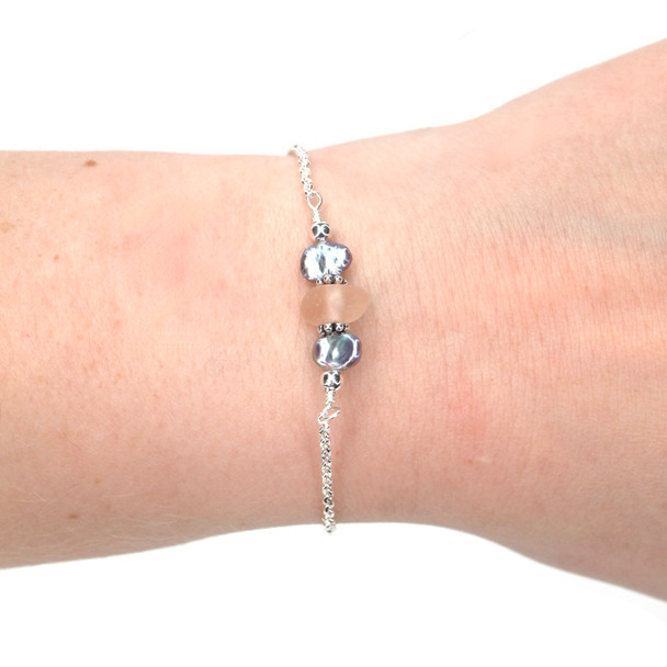 Pink Sea Glass and Dainty Peacock Pearl Bracelet on model for color reference.